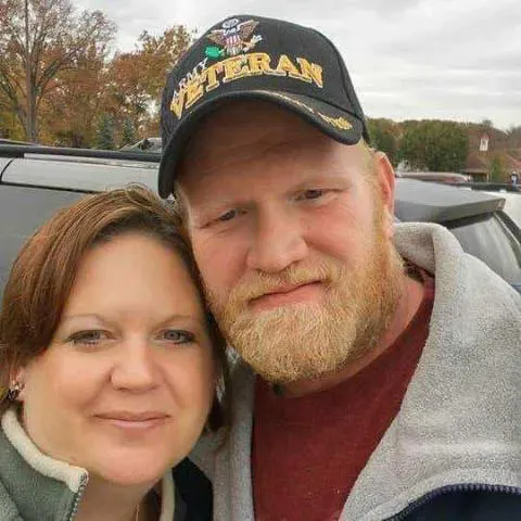 Jason, owner of Bates HVAC, in a US Army veteran cap, with his wife